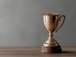© Doggie Portraits - Golden trophy symbolizes achievement on wooden table against neutral backdrop in bright setting