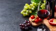 © Matthew - A beautifully arranged wine glass beside fresh grapes and tomatoes on a wooden board