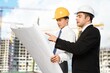 © BillionPhotos.com - Engineering people at work at construction site.
