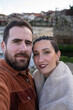 © asier - Cheerful couple capturing selfie moment with historic combarro village nestled along galician coastline, embracing scenic travel experience in northwestern spain
