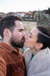 © asier - Romantic couple kissing on cobblestone street, traditional horreos framing picturesque coastal scene in combarro, galicia, spain