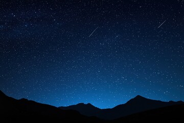 Wall Mural - shooting stars streak across a deep blue, starry night sky over the silhouette of a tranquil mountai