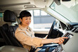 © Davor - Professional Asian businesswoman driving a car