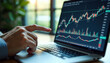 © Vladimir - Hand pointing at laptop financial chart for investment blogs and financial advisors