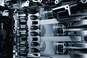 Poster - A close up of a car engine with the pistons and cylinders visible. Concept of complexity and precision, as the various components of the engine work together to create power and motion
