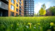 © TITISCAHYA - Lush green grass in front of modern apartment buildings