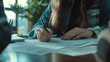 © Tahsin - Woman signing important documents at wooden table closeup view pen job hand work desk focus office