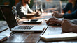 © makappa - A laptop is open during a meeting at a wooden table