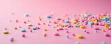 Vibrant sprinkles scattered on pastel pink, close-up , background, decoration, sugar art