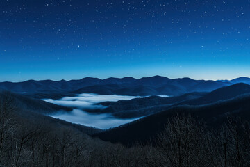 Wall Mural - Starry night over a serene mountain landscape with mist filling the valleys, creating a mystical and tranquil atmosphere under the clear, starry sky.