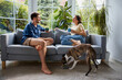 © baranq - Couple at home sitCouple at home sitting on sofa having coffee talking ting on sofa having coffee