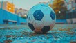 © Dece Std - Well-worn soccer ball rests on a field