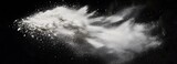 A soft, cloud-like explosion of finely milled setting powder in mid-air on an isolate background