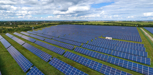 aerial view of large sustainable electrical power plant with rows of solar photovoltaic panels for p