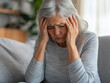 © Jay - senior woman suffering from headache