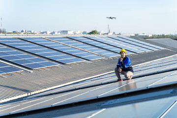 Wall Mural - renewable energy concepts.electrical engineers are using laptops to monitor the operation of the sol