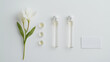 © Karlicia - A modern flat lay arrangement with small glass vials, one white flower, and a blotter strip, all placed on a crisp white backdrop.
