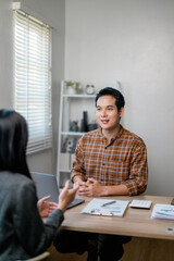 Poster - Two asian businesspeople discussing together during a meeting in office