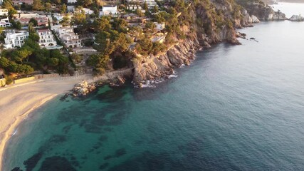 Wall Mural - Experience a stunning aerial view of a coastal village by the beach. Clear waters and cliffs create an ideal setting for summer vacations and relaxation.