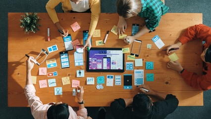 Wall Mural - top view of software developer team looking ux ui design for mobile phone interface from tablet whil
