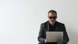 © KASUEMA SALAE - A man with sunglasses, sitting in a coffee shop, looking at his laptop with a relaxed expression, on a white isolated background