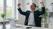 © rdkcho - Happy Businessman Celebrating Success at His Desk