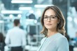 © Tondone - A confident businesswoman wearing glasses stands in an office environment, showcasing professionalism and modern workplace dynamics. A perfect image for corporate themes.