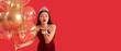 © Pixel-Shot - Beautiful Asian prom queen with balloons blowing kiss on red background