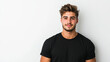 © NaphakStudio - young man with stylish hair wearing black t shirt, smiling against light background.