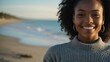© Alteisen Riese - Good-looking young african gal in gray themed sweater on a beach smiling