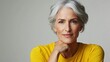 © Mrammon - A woman with gray hair is wearing a yellow shirt and is smiling