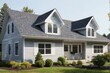 © piyawat - Charming TwoStory Gray House with Black Roof, Front Porch, Dormer Windows, and WellManicured Lawn in Blue Sky Setting