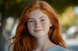 © Lens Sculptor - Portraits of a charming red-haired girl with a cute face. Girl posing for the camera in the city center. She has a wonderful mood and a lovely smile