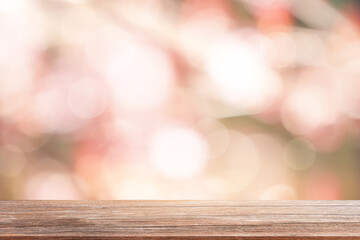Poster - Wood table top on blur abstract green and pink from sunlight in the morning for product design background,Brown wooden mock up for display board or podium for Easter,Food and Drink for Summer holiday