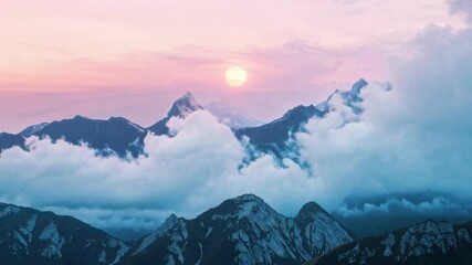 Wall Mural - Majestic mountain peaks with pink sunset and clouds. Serene nature concept