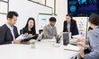 © SOMKID - Group of business people working together with dashboard analysis and data management a meeting table in office.