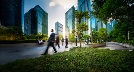 Poster - Blurred figures walk in a park amidst towering skyscrapers. Lush greenery and trees provide a natural contrast to the modern urban architecture.