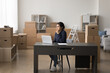 © fizkes - Sales manager workday. Pensive young woman small ecommerce business owner sit at workplace in storehouse with packed goods think on inventory documents tax payments plan shipment time logistics costs