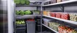 © Duskcraft - Fresh produce and ingredients organized on shelves in a commercial kitchen walk in refrigerator storage for restaurant use