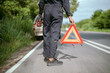 © 2B - Roadside assistance with warning triangle on a rural road during the day