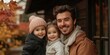 © Michael - Smiling father enjoys autumn day with daughters amid colorful falling leaves in a cozy neighborhood