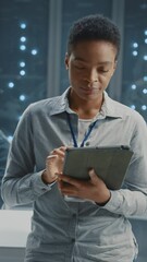 Wall Mural - portrait african american female employee it administrator cooperating in supercomputer server room.