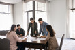 © fizkes - Five professionals analyzing data, reviewing papers laid out on conference table. Team working on detailed analysis for business project, strategy development, or problem-solving, make strategic plans