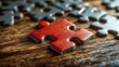 © Ali - Red puzzle piece on wooden surface, solution concept.