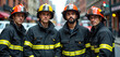 © Vadym - Group of firefighters in uniform stand on city street. Firemen team wearing protective helmets and jackets pose. Brave fire fighters ready to serve, show unity and readiness.