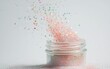 © creatfive - Pink Glitter Spilling from Jar on White Background