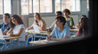 © EFStock - Group of teenager students listening to professor lecture at college school classroom