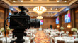 © Sara - A professional camera on the blurred background of a banquet hall.