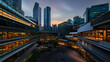 © artzone - Modern Cityscape At Twilight Illuminated Buildings And Reflective Surfaces Against A Colorful Sky