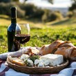 © Faizal - Rustic picnic setting with red wine cheese and bread on a blanket in the countryside during golden hour
